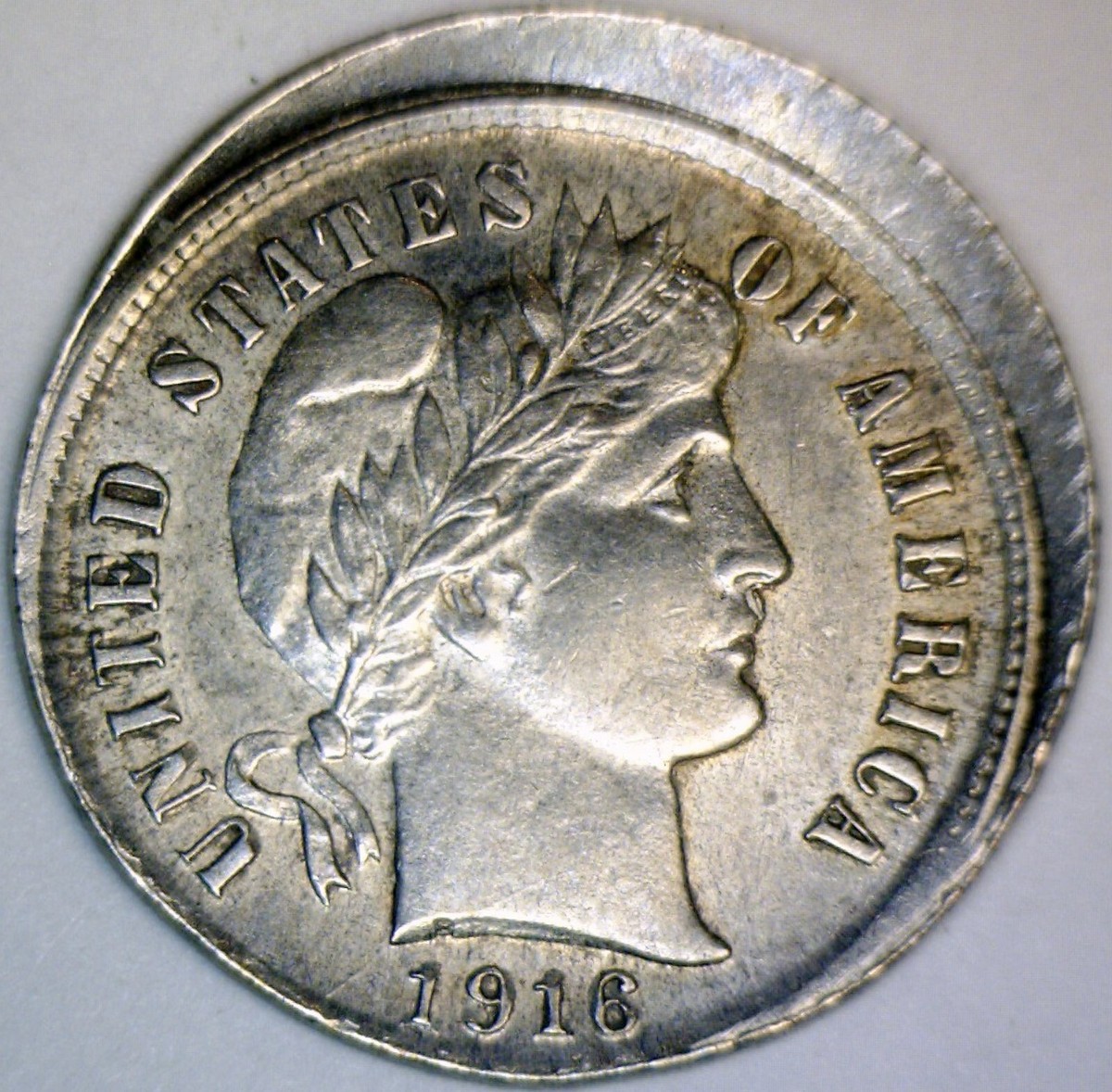 1916 Barber quarter off-center strike error — obverse showing shifted design with exposed planchet crescent